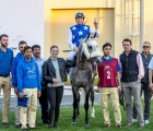 The connections of Zamer pose for a photo after their win. 