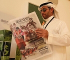 Un appassionato locale legge il programma corse di Arab News